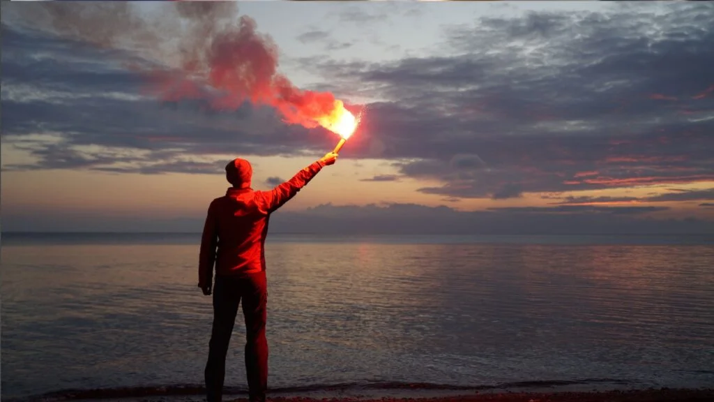 a man holding a signal flare