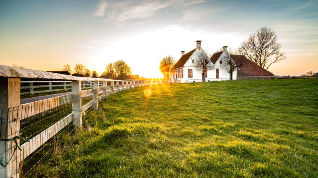 beautiful-shot-fence-leading-house-green-grass-area