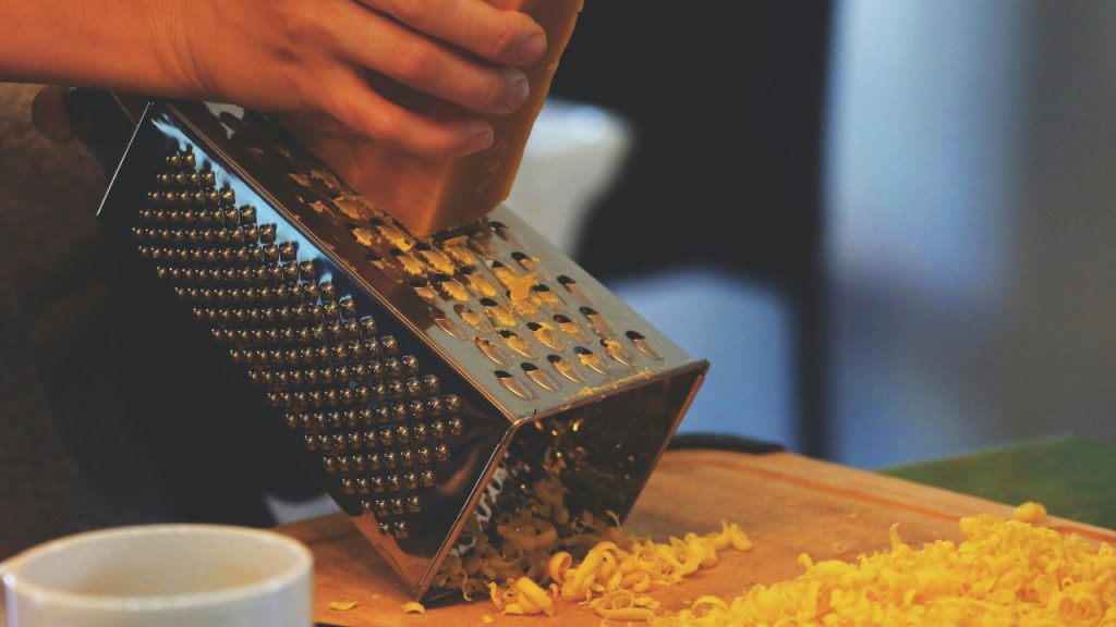 Person grating cheese